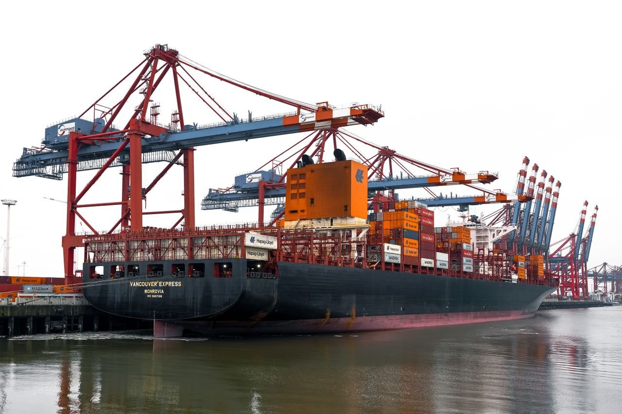 Vivid scene of container ships and cranes at the bustling Hamburg Port in Germany.