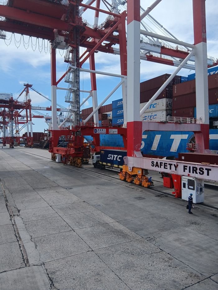 A dynamic view of container cranes and cargo operations at a port in the Philippines.